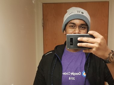 A mirror selfie of Pranav Mahajan wearing the google code in tshirt.