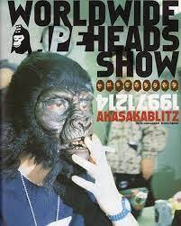 promotional poster for a World Wide Ape Head show featuring a man smoking a cigarette in a planet of the apes mask