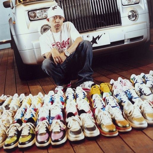 Nigo standing in front of dozens of pairs of Bapestas