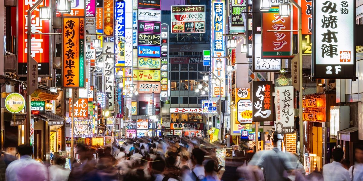 a bustling street in Tokyo with vibrant neon lights