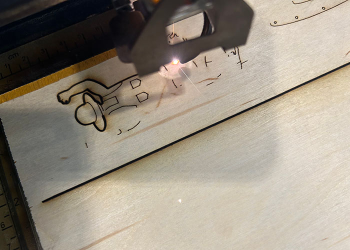 The automata's farmer character being laser cut.