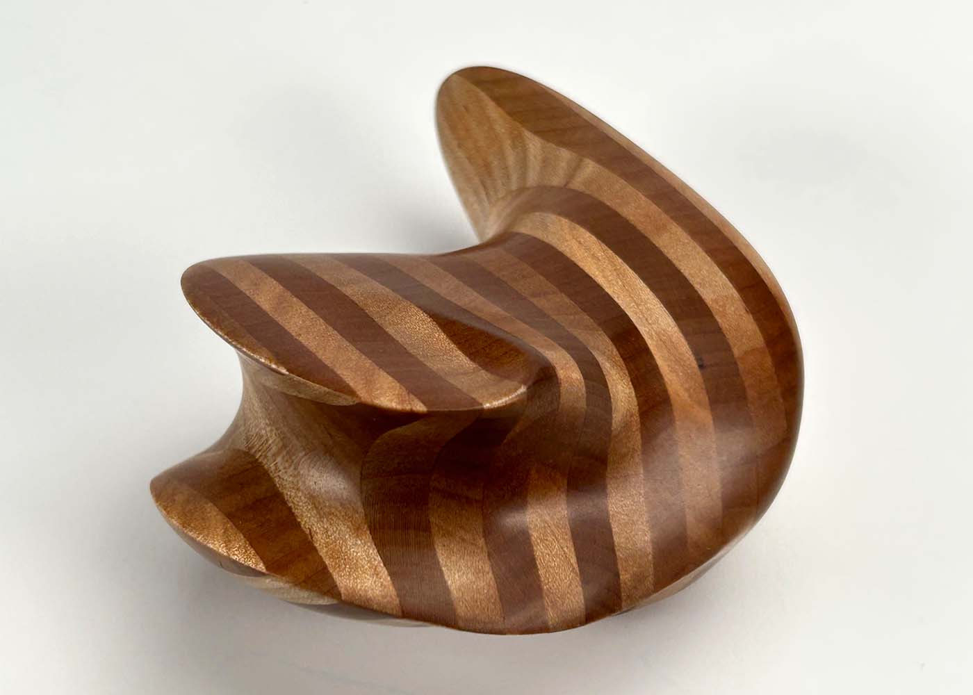 A handheld, striped wooden monolith.