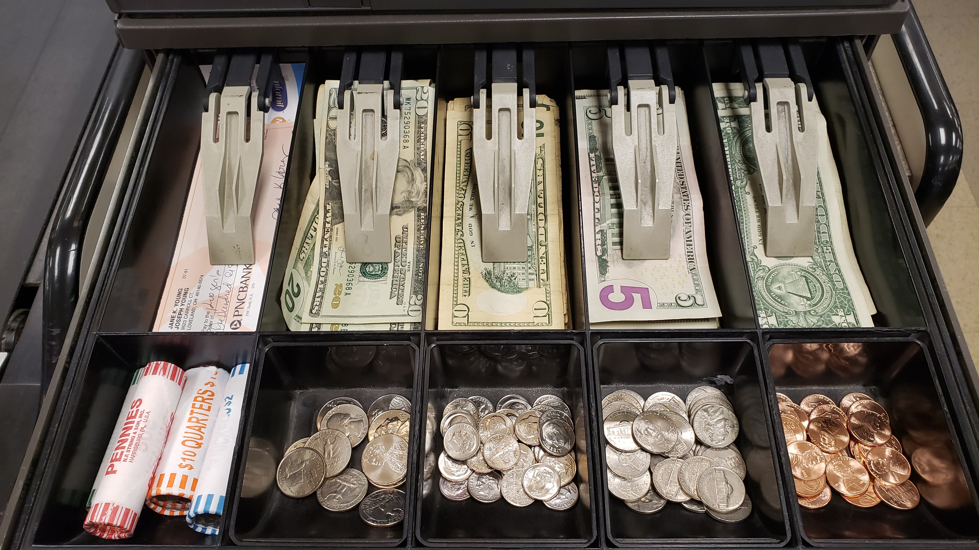 Image of the register's cash drawer. Look at all that money!