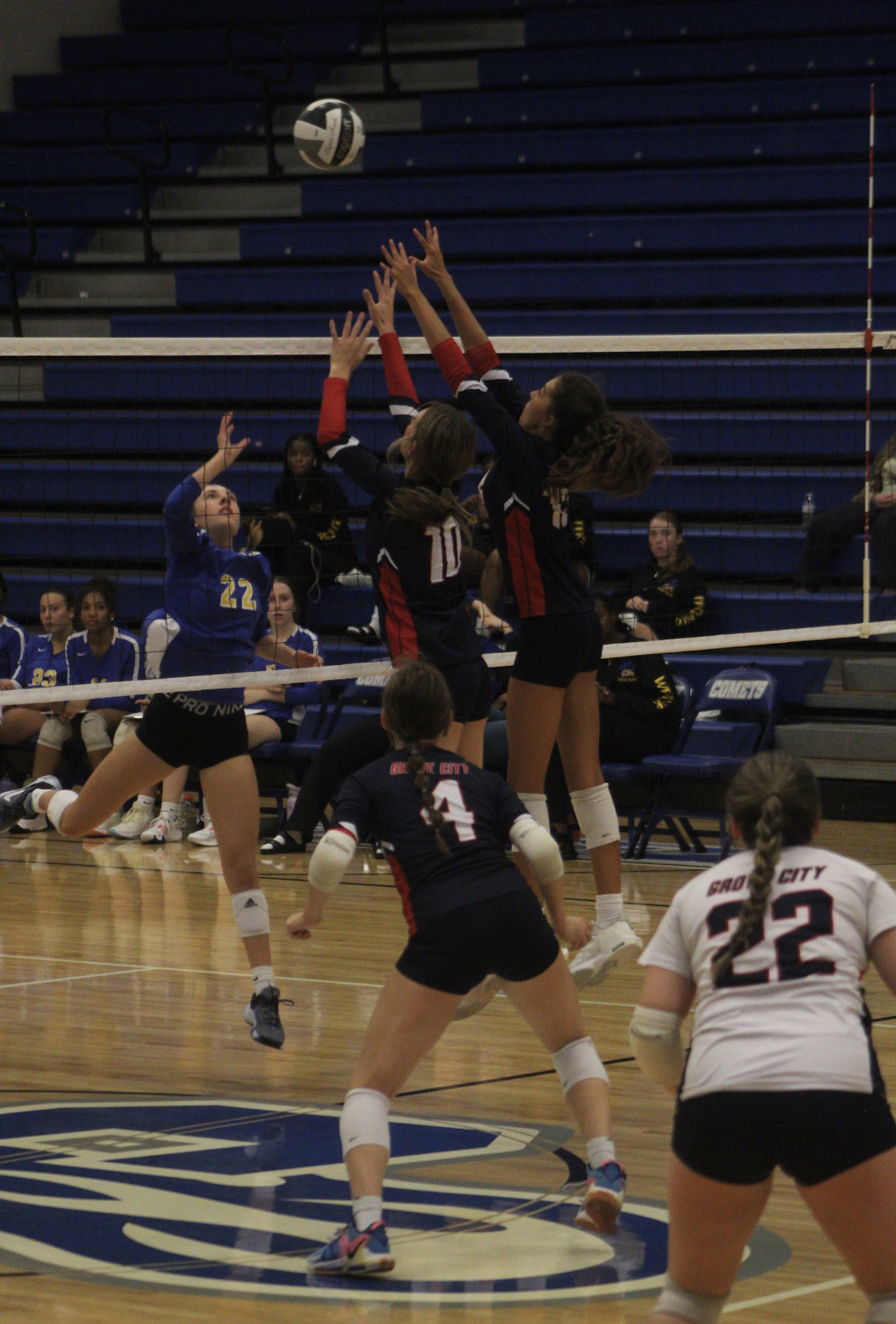 girls jumping at volleyball