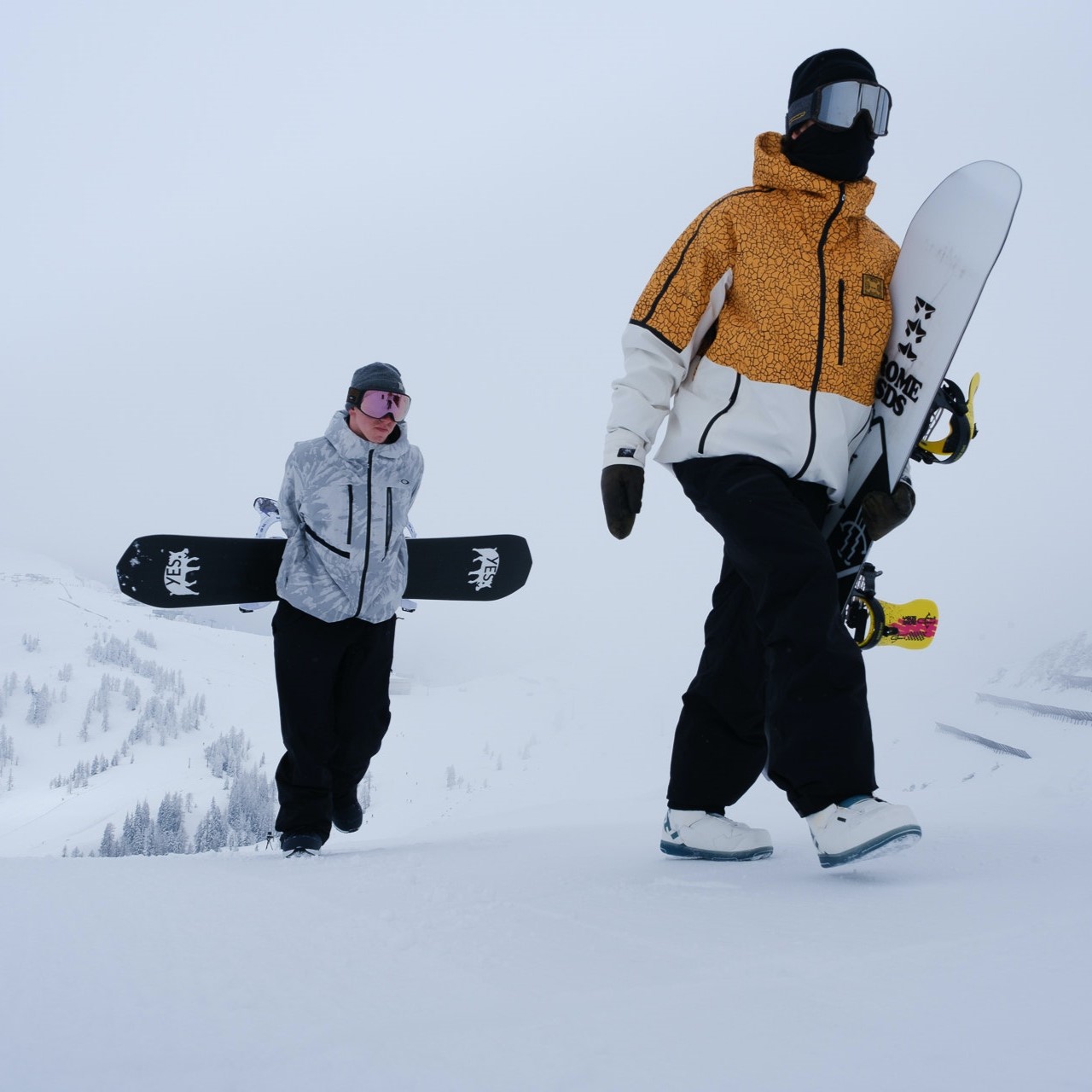 A picture of two well-dressed snowboarders