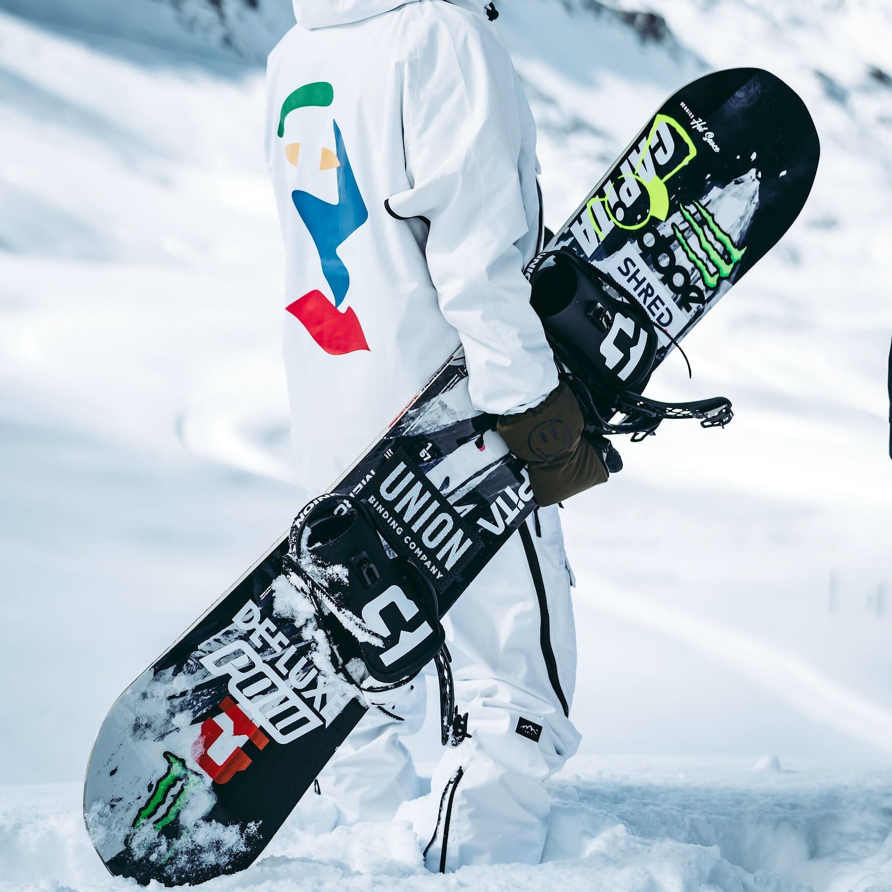 A close-up picture of someone holding a snowboard